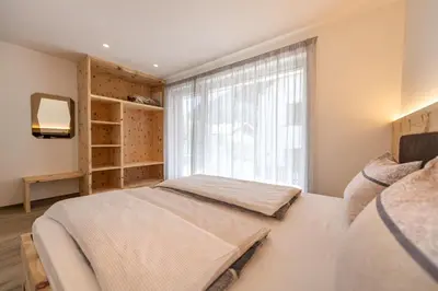 a bedroom with two beds and a window at Apartment Dauru in Ortisei