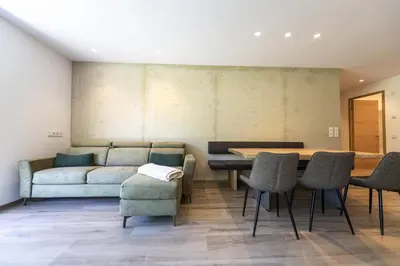 a living room with a couch and a table and chairs at Apartment Dauru in Ortisei
