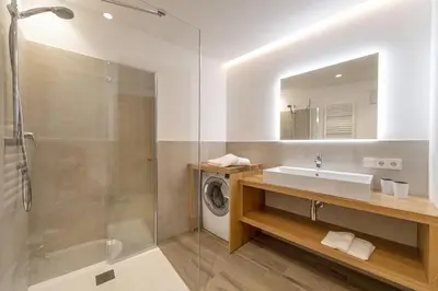 a bathroom with a sink and a washing machine at Apartment Dauru in Ortisei