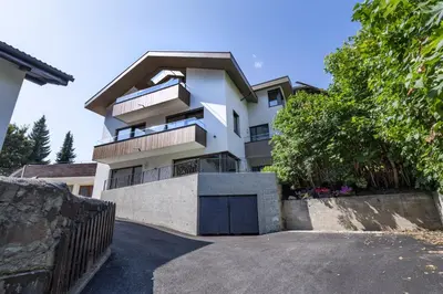 a white house with a driveway at Apartment Dauru in Ortisei