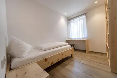 a small bedroom with a bed and a window at Apartment Dauru in Ortisei