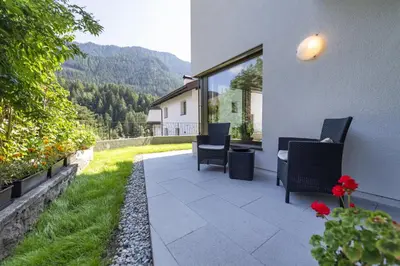 a patio with chairs and a table with a view at Apartment Dauru in Ortisei