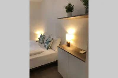 a small bedroom with a bed with lights on it at Brunico 19 in Brunico