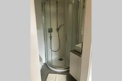 a bathroom with a shower with a glass shower at Brunico 19 in Brunico