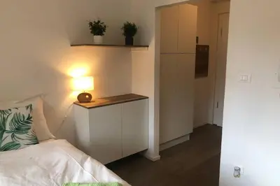 a bedroom with a bed and a table with a lamp at Brunico 19 in Brunico