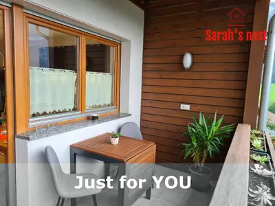 a patio with a table and chairs and a window at Sarah's nest - your mountain resort in Villa Ottone