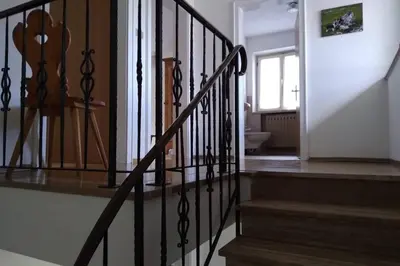 a staircase in a house with a stair railing at Relax al lago di Braies in Braies