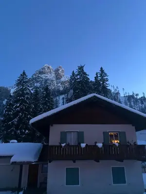 a house with a balcony with snow on it at Relax al lago di Braies in Braies