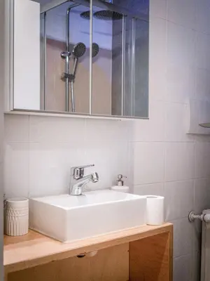a bathroom with a white sink and a mirror at Bergblick Apartment in Zentrumsnähe mit Garage in Merano