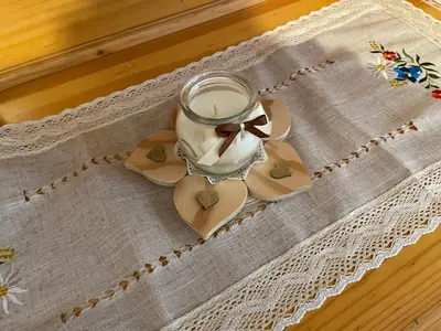 a glass jar with a bow on a table at Appartamento Edelweiss in Fiera di Primiero