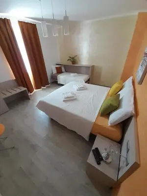 a large bedroom with a large white bed and a room at B&B ANGELA Valdinon in Predaia