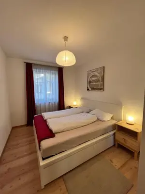 a bedroom with a large bed with two lights on it at Für 4-6 Wohnhaus im Weinberg - Voldersberghof in Penone