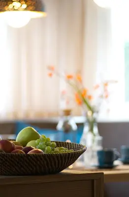 a bowl of fruit on a table in a kitchen at CityChalet family Bozen in Bolzano