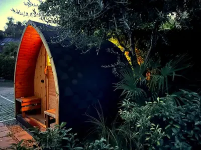 a small shed with a bench in a garden at CityChalet family Bozen in Bolzano
