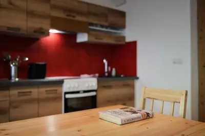 a kitchen with a wooden table with a book on it at Veraltenhof Agriturismo B&B in Tires
