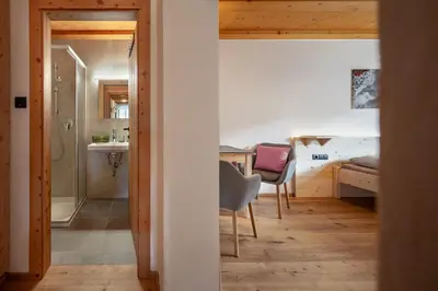 a room with a desk and a chair and a bedroom at Veraltenhof Agriturismo B&B in Tires