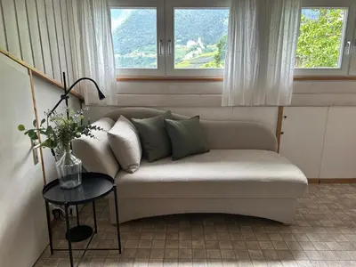a living room with a couch and a table at Villa Corazza-Bezauberndes Appartment+ Schwimmbad in Tirolo