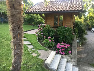 a small house with a bench in the yard at Villa Corazza-Bezauberndes Appartment+ Schwimmbad in Tirolo