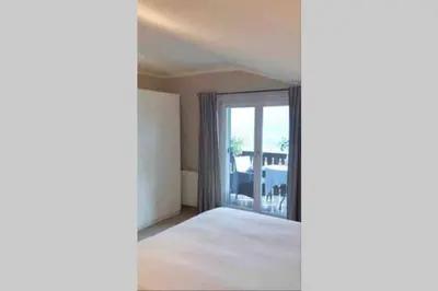 a room with a bed and a sliding glass door at Villa Corazza-Bezauberndes Appartment+ Schwimmbad in Tirolo