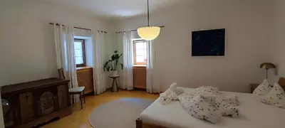 a small bedroom with a bed and a window at Große Wohnung mit Garagenparkplatz in Vols am Schlern