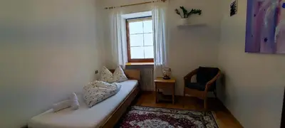 a small room with a couch and a window at Große Wohnung mit Garagenparkplatz in Vols am Schlern