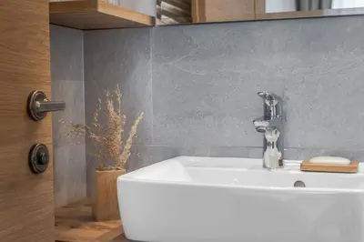 a bathroom with a white sink in a room at Villa Resi B&B in Corvara in Badia
