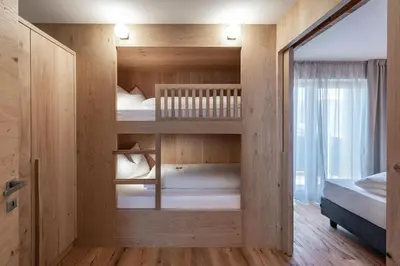 a room with two bunk beds and a window at Guesthouse Plose in Bressanone