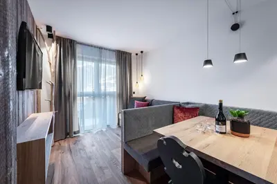 a living room with a table and a couch at Guesthouse Plose in Bressanone