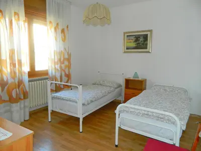 a bedroom with two beds and a window at 