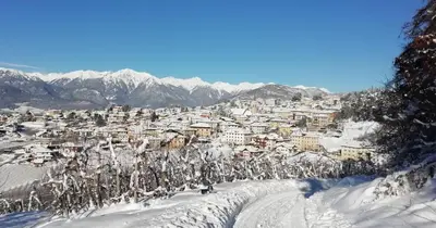 a ski slope with a town in the snow at 