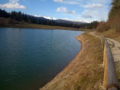 a body of water next to a wooden fence at 