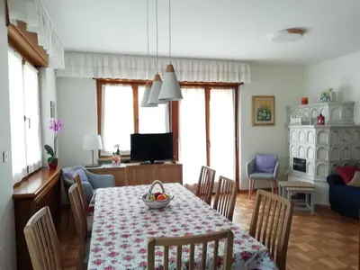 a dining room with a table and chairs and a living room at 