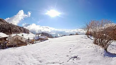 a snow covered hill with the sun in the sky at B&B Gasthaus Lieg in Castelrotto