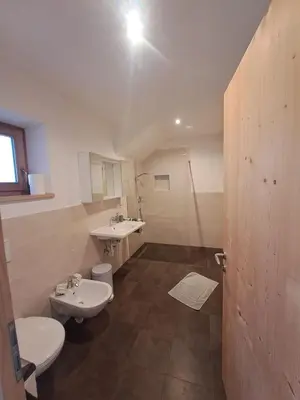 a bathroom with two toilets and a sink at B&B Gasthaus Lieg in Castelrotto