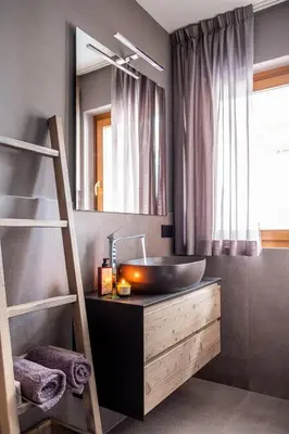 a bathroom with a sink and a mirror at Suite Mia in Falcade