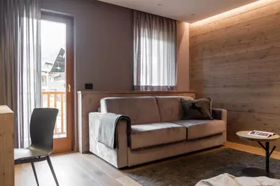 a living room with a couch and a window at Suite Mia in Falcade
