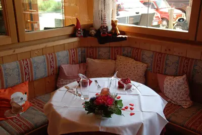 a table with flowers on it in a restaurant at Gasthof zum Schlern in Fiè