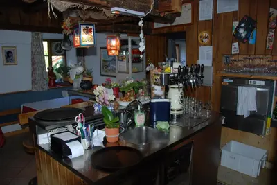 a kitchen with a counter top with flowers on it at Gasthof zum Schlern in Fiè
