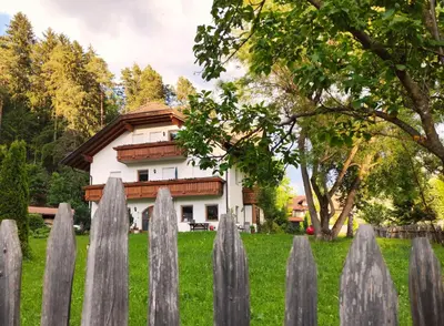 a fence in front of a house at Maurerhof Apartments Kronplatz in San Lorenzo di Sebato