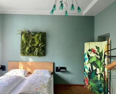 a bedroom with a bed and a painting on the wall at sleep & go -Meran easy staying in Merano
