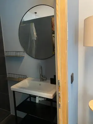 a bathroom with a sink and a mirror at sleep & go -Meran easy staying in Merano