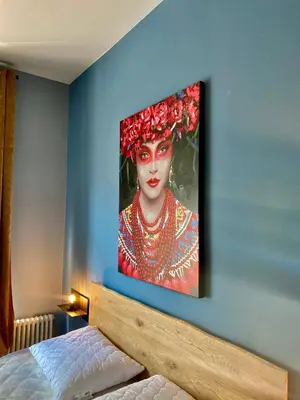 a painting of a woman on a blue wall at sleep & go -Meran easy staying in Merano