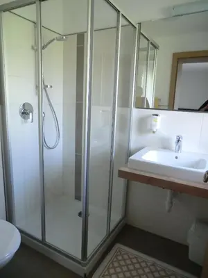 a bathroom with a shower and a sink at Garni Pircher in Tirolo