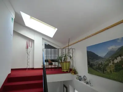 a staircase in a house with a painting on the wall at Garni Pircher in Tirolo