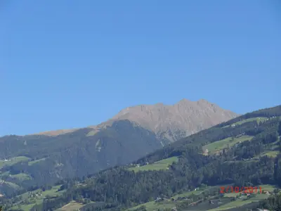 a view of a mountain range with a red sign at Garni Pircher in Tirolo
