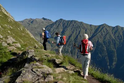 a group of people walking on a mountain trail at Garni Pircher in Tirolo