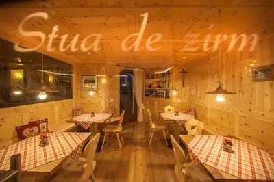 a restaurant with tables and a sign that reads chili cafe at Hotel Garni Aghel in Selva di Val Gardena