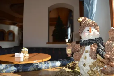 a statue of a snowman sitting on a table at Hotel Villa Aurora in San Martino di Castrozza