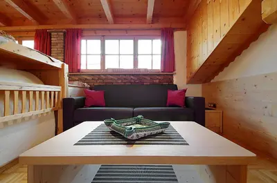 a living room with a couch and a table at Appartamenti Pastüres in Colfosco