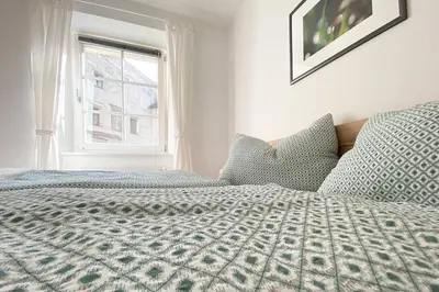 a bedroom with a bed and a window at In Urbi, city appartement in Bressanone